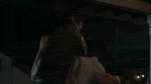 a man and a woman are kissing in a dark room