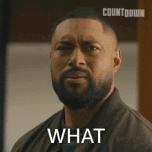 a man with a beard is making a funny face and the word what is above him