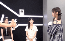 a woman in a black and white striped shirt stands in front of a youtube logo