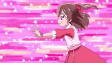 a girl in a pink dress is dancing with her arms outstretched