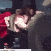 a woman is sleeping in the back seat of a car with a bottle of water .