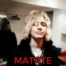 a picture of a blonde haired man with the word matate in red