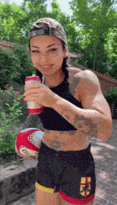 a woman holding a can of beer and a rugby ball