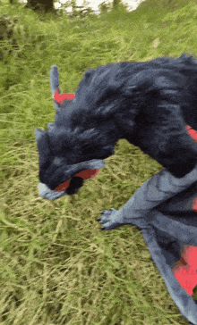 a stuffed animal that looks like a dragon is flying through the air