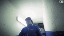 a man in a dodgers jacket is walking down a staircase .