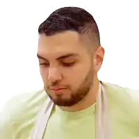 a man with a beard is wearing a green shirt and an apron around his neck