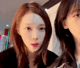 two girls are standing next to each other and one of them has a sticker on her face that says ' a '