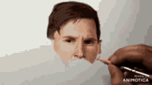 a person is drawing a man 's face with a pencil ..