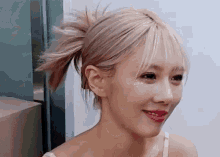 a close up of a woman 's face with a ponytail and red lips