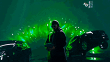 a man is holding a fan of money in front of a green background that says tiktok