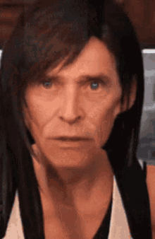 a close up of a man 's face with a wig on
