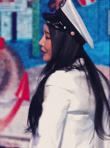 a woman wearing a white jacket and a white hat