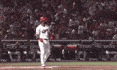 a baseball player wearing a red and white jersey with the number 11 on it