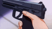 a person is holding a gun in their hand in a close up .