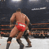 two men are wrestling in a ring with a sign that says backlash