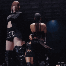 a woman in a black outfit has a belt that has holes in it