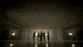 a group of women are dancing in a room with a marble floor