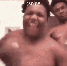 a shirtless man is making a funny face while standing next to two other men .