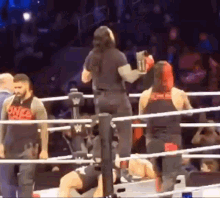 a man is standing in the middle of a boxing ring holding a bottle of beer .