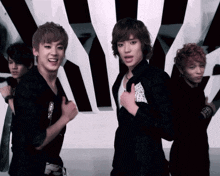 a group of young men are posing for a picture in front of a zebra print wall