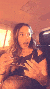 a woman in a car with her mouth open
