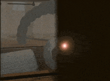 a red light is shining through a doorway in a dark room