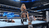 a woman in a wrestling ring with a sign that says fmack on it