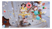 a girl in a yellow dress is surrounded by balloons