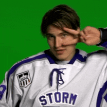 a young man wearing a storm jersey making a peace sign