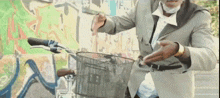 a man in a suit rides a bike with a basket
