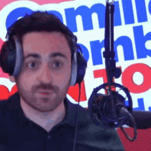a man wearing headphones stands in front of a microphone in front of a sign that says miller 's radio