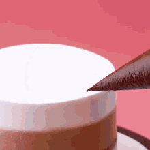 a cup of coffee is being decorated with a chocolate cone