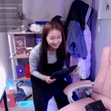 a woman is holding a tablet in front of a screen that says " much it cost just the "