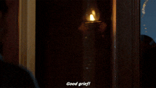 a man holding a lamp that says good grief on it