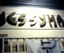 a sign on a wall that says ' jesus ' in arabic