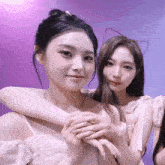 two girls posing for a picture with one wearing a cat ear