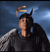 a man with angel wings and a feather crown on his head