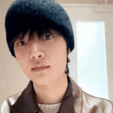 a close up of a person wearing a hat and a jacket