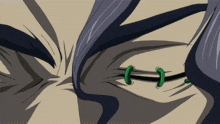 a close up of a person 's eye with green rings in it