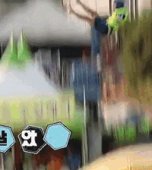 a blurry picture of a person hanging from a building with a sign that says ' a '
