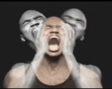 a man is screaming with two faces behind his head
