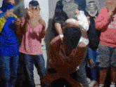 a group of people wearing masks with one wearing a sweater that says ' aires ' on it