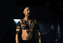 a man without a shirt has a tattoo on his chest that says go