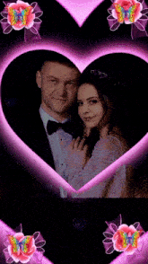 a man and a woman are in a heart surrounded by pink butterflies