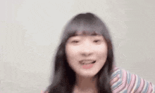a close up of a woman 's face with a blurry background .