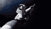 a man in an astronaut 's suit is flying in space .
