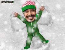 a man in a green candy cane pajamas is making a snow angel with his arms outstretched