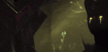 a close up of a person 's face with glowing eyes in a dark room