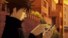 a person looking at a cell phone with a building in the background