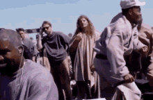a group of people in purple shirts are standing in a line